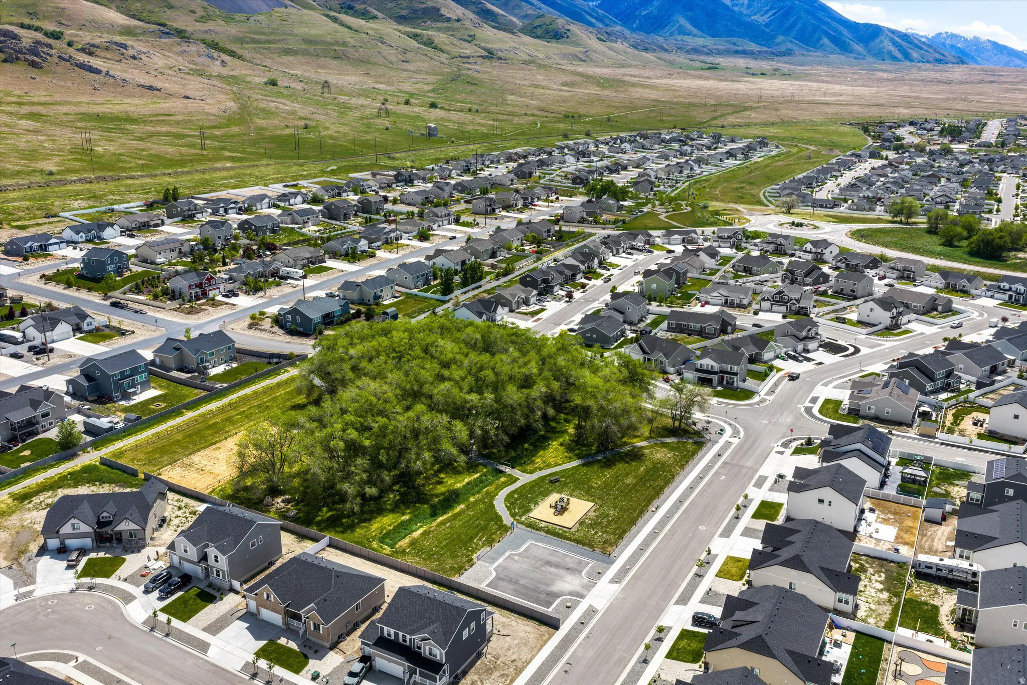 Aerial perspective of suburban area featuring a mountainous background