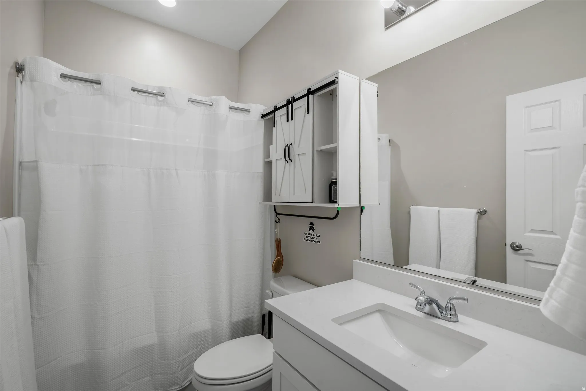Bathroom with vanity and a shower with shower curtain