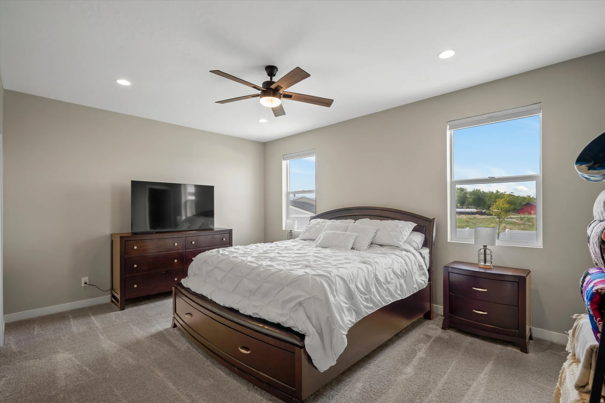 Bedroom featuring ceiling fan, recessed lighting, and light colored carpet