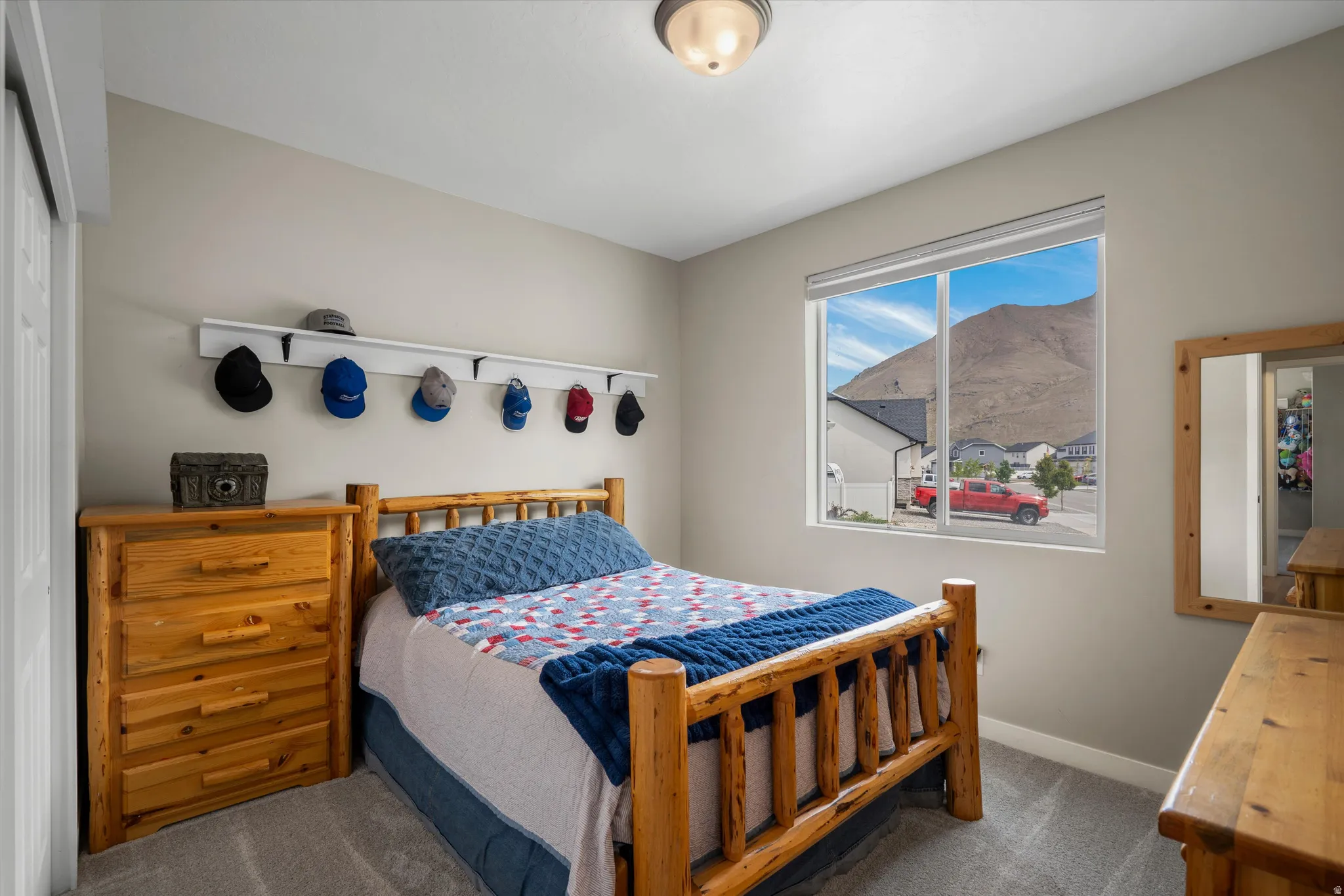 Bedroom with dark colored carpet and baseboards