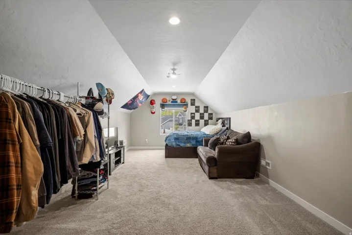 Bedroom with a textured ceiling and light carpet