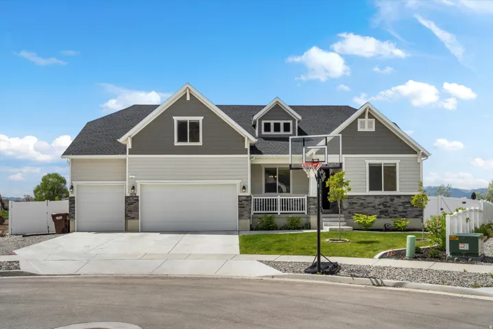 Craftsman inspired home with stone siding, a gate, concrete driveway, and a porch