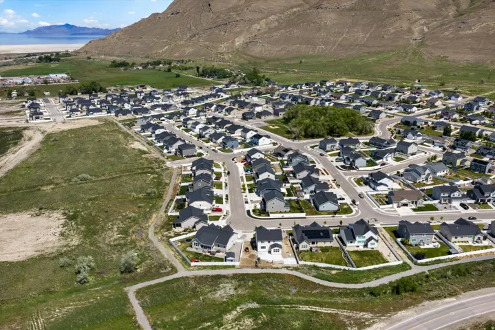 Aerial view of property and surrounding area with nearby suburban area and a mountainous background