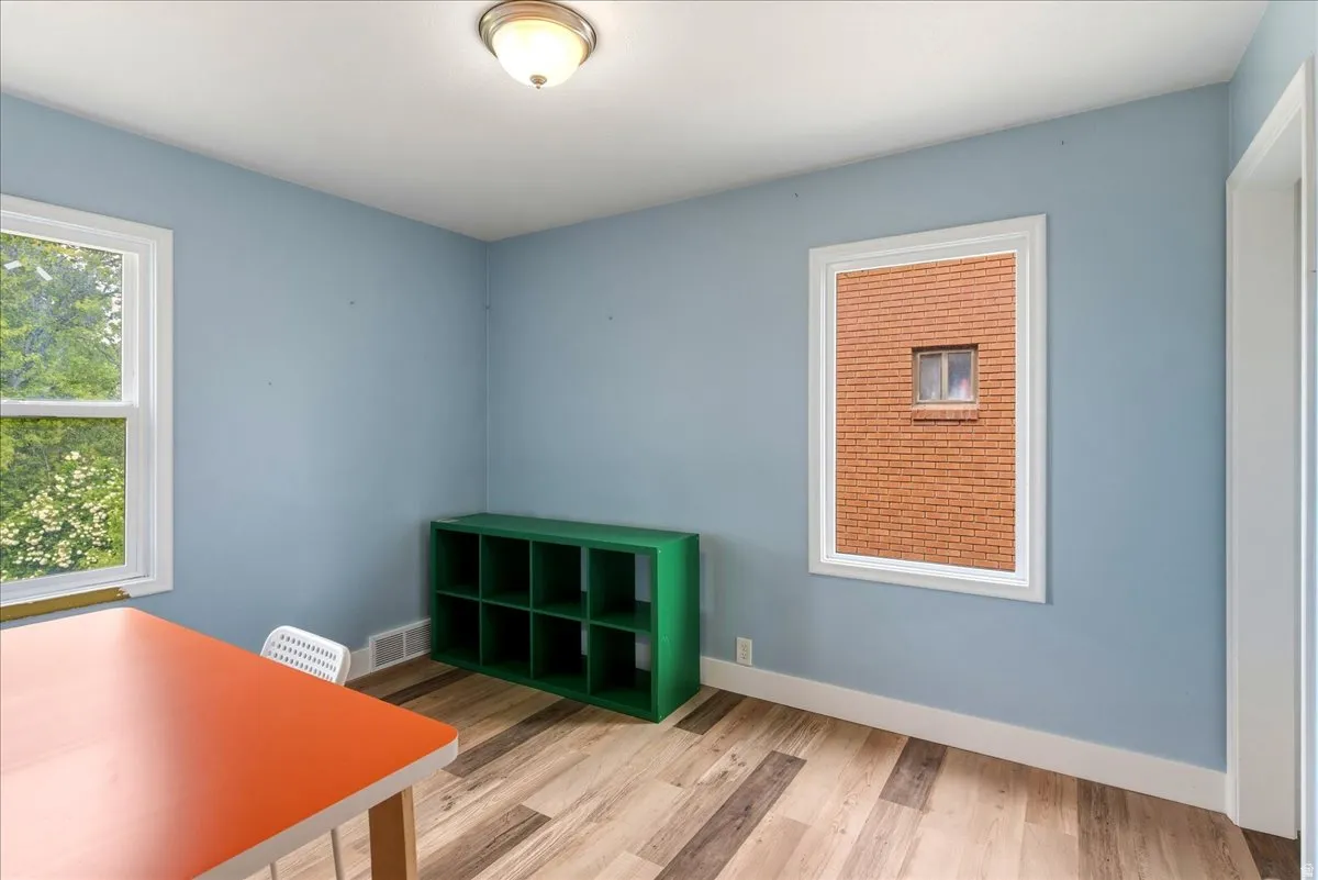 Unfurnished office featuring light wood-style floors and baseboards