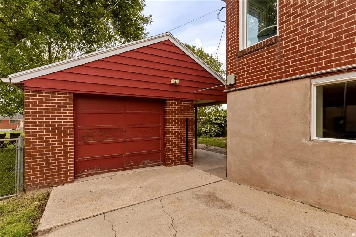 Detached garage featuring concrete driveway