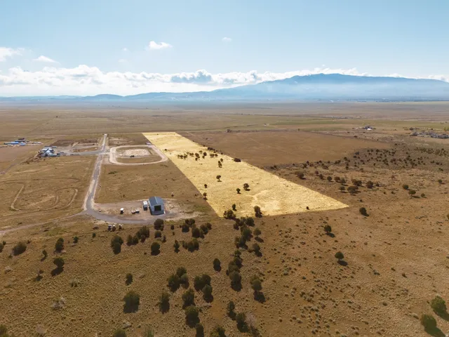 Aerial view of sparsely populated Cedar Valley area with a mountainous background