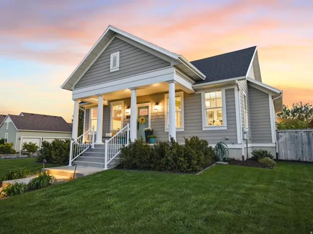 View of front of property featuring a porch and roof with shingles