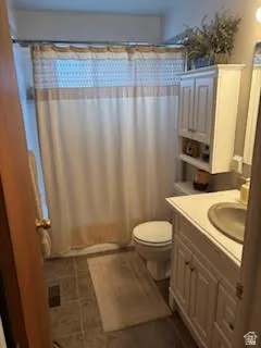 Bathroom featuring vanity and curtained shower