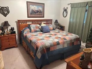 Bedroom featuring light carpet
