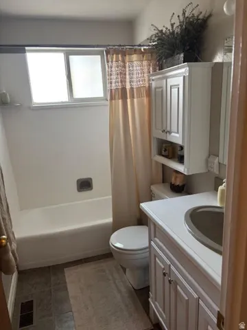 Full bath featuring vanity and shower / tub combo with curtain