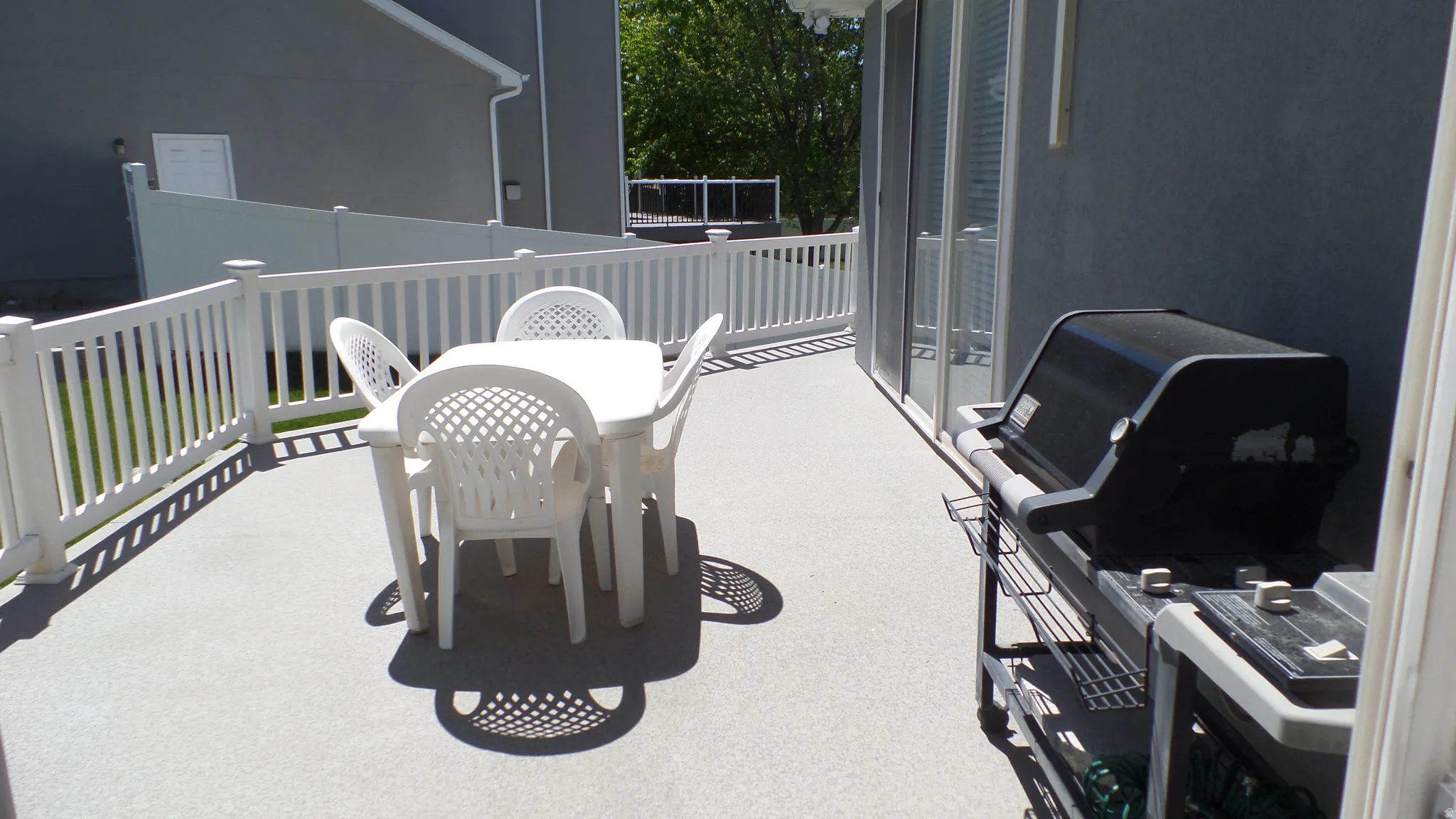 View of patio featuring outdoor dining area and a grill