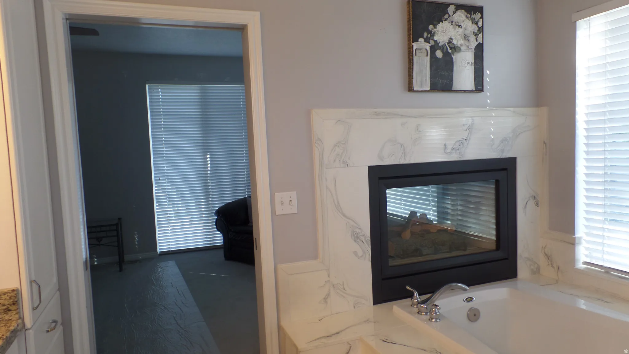 Owners Ensuite - 2-Way Fireplace between Soaking Tub & Sitting Area