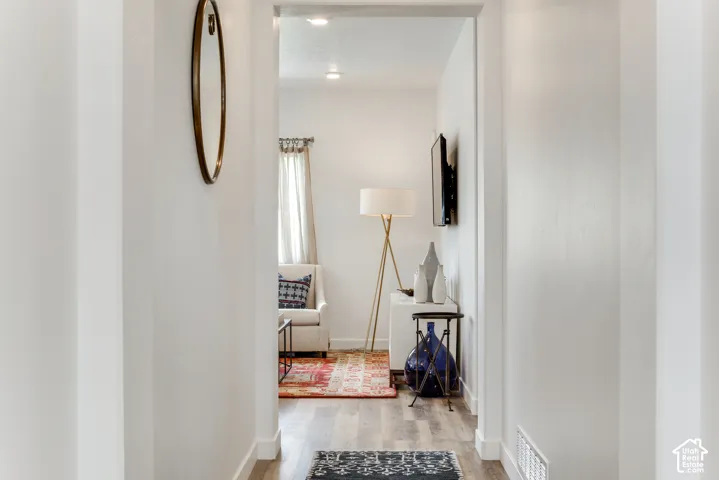 Hallway featuring wood-finish flooring and recessed lighting