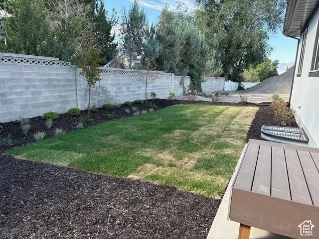 Manicured lawn area with surrounding dark mulch beds