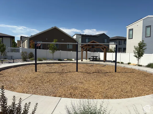 Community playground featuring a wooden swing set over wood chip surfacing