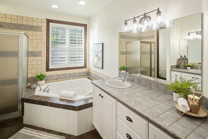 Bathroom featuring vanity, a stall shower, a bath, and recessed lighting