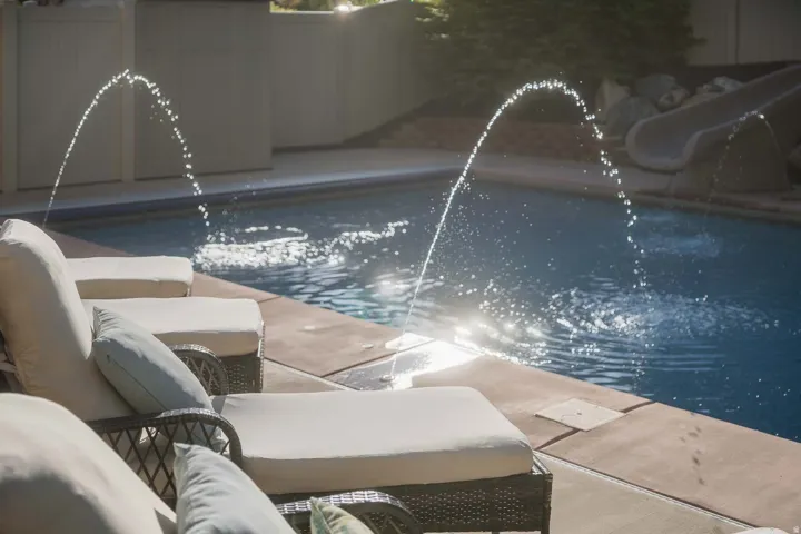 View of swimming pool with a water slide