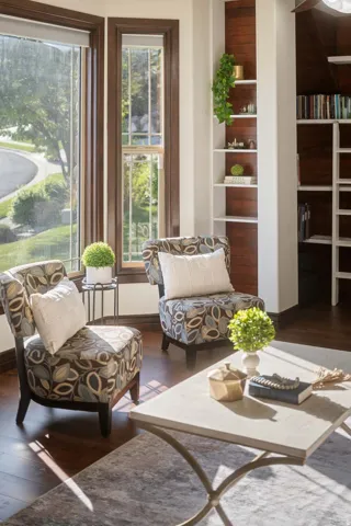 Living area with dark wood finished floors and baseboards