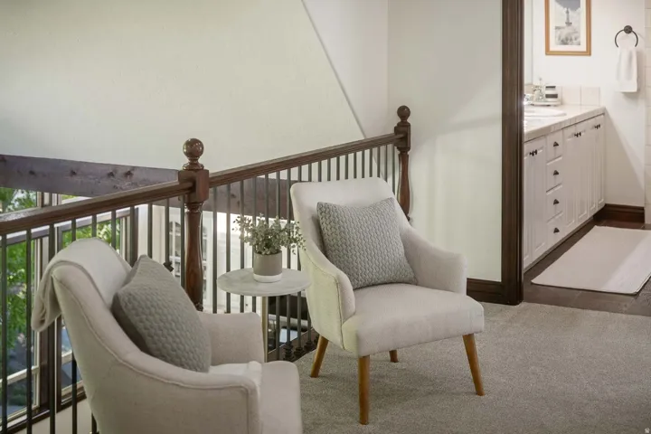 Sitting room with baseboards and carpet flooring