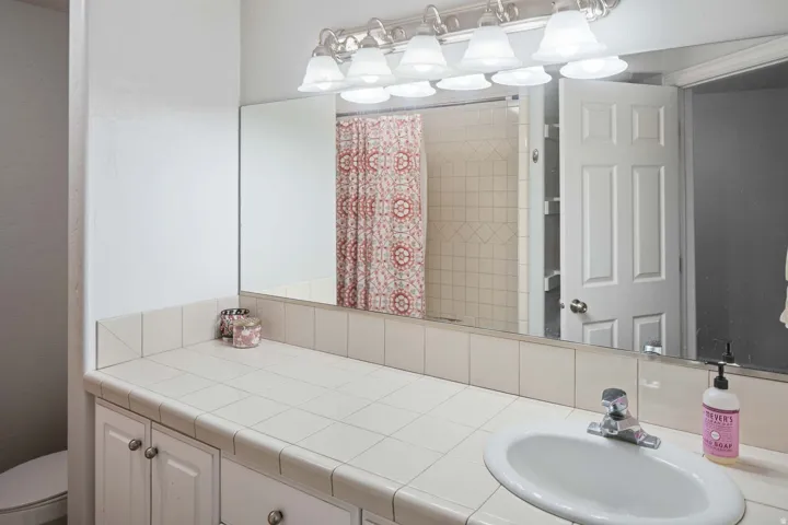 Full bath with vanity and a shower with curtain