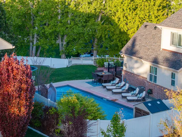 View of swimming pool with a fenced backyard and patio surround