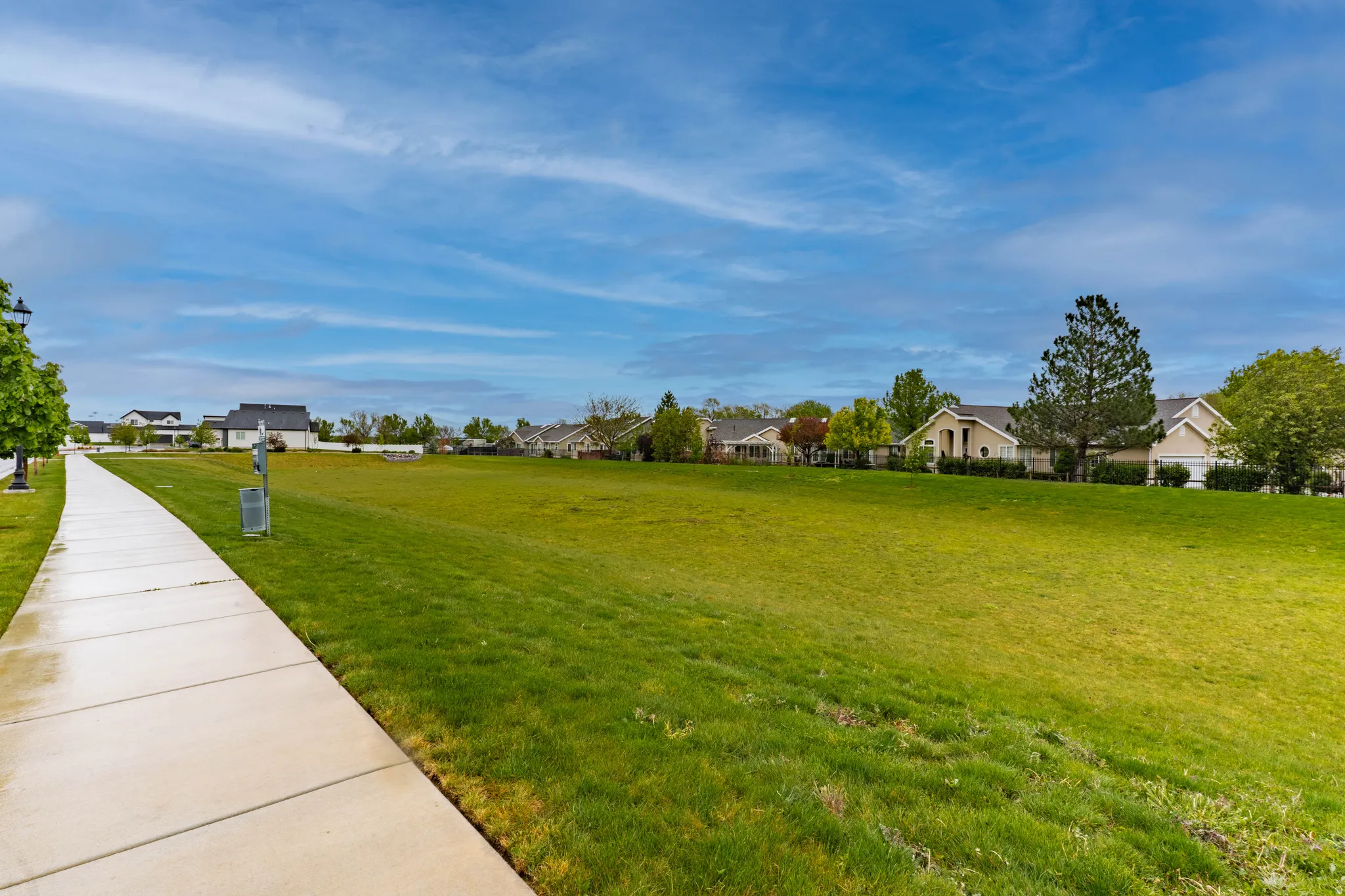 View of green lawn featuring a residential view