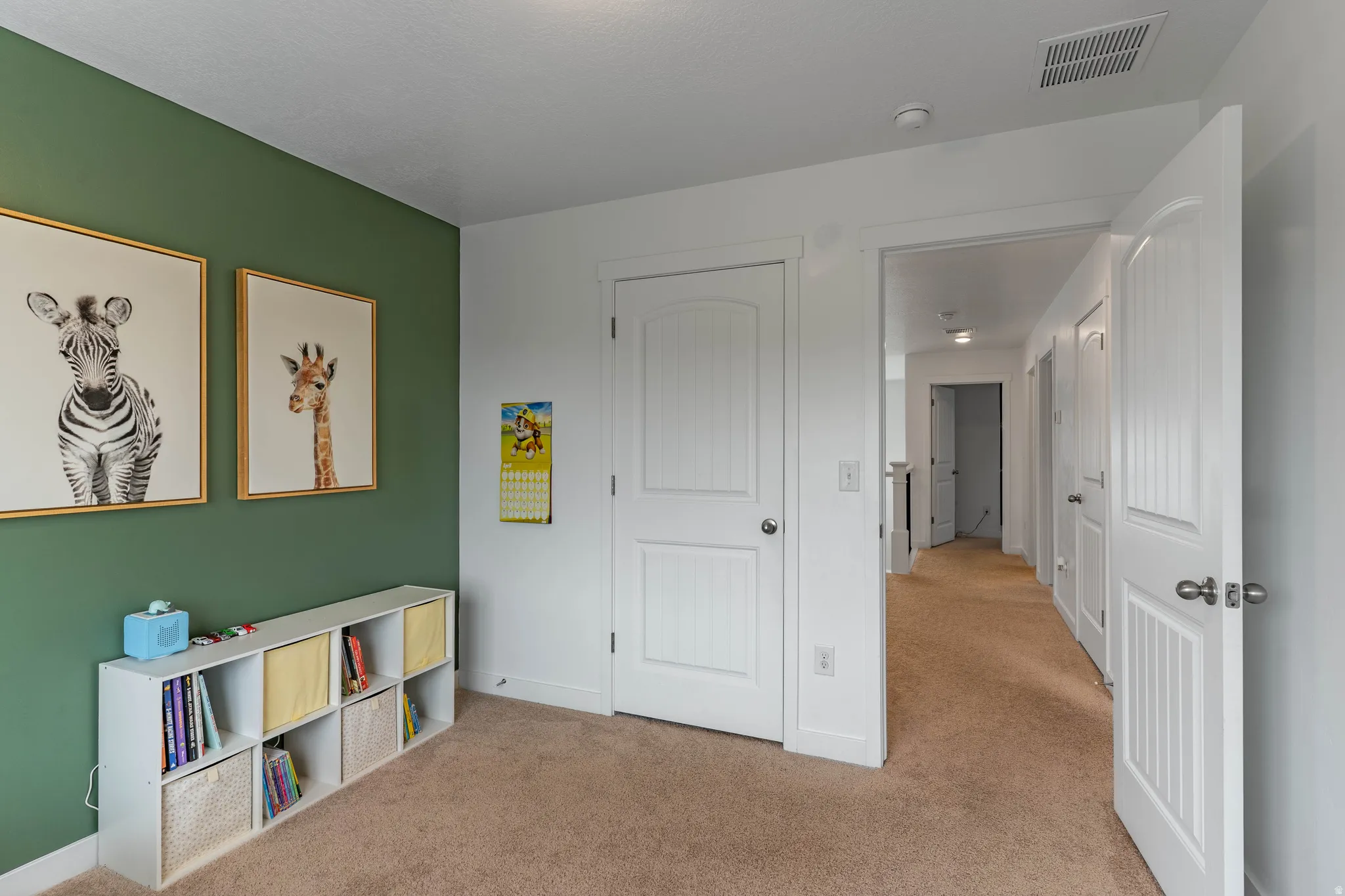 Bedroom with light carpet and baseboards
