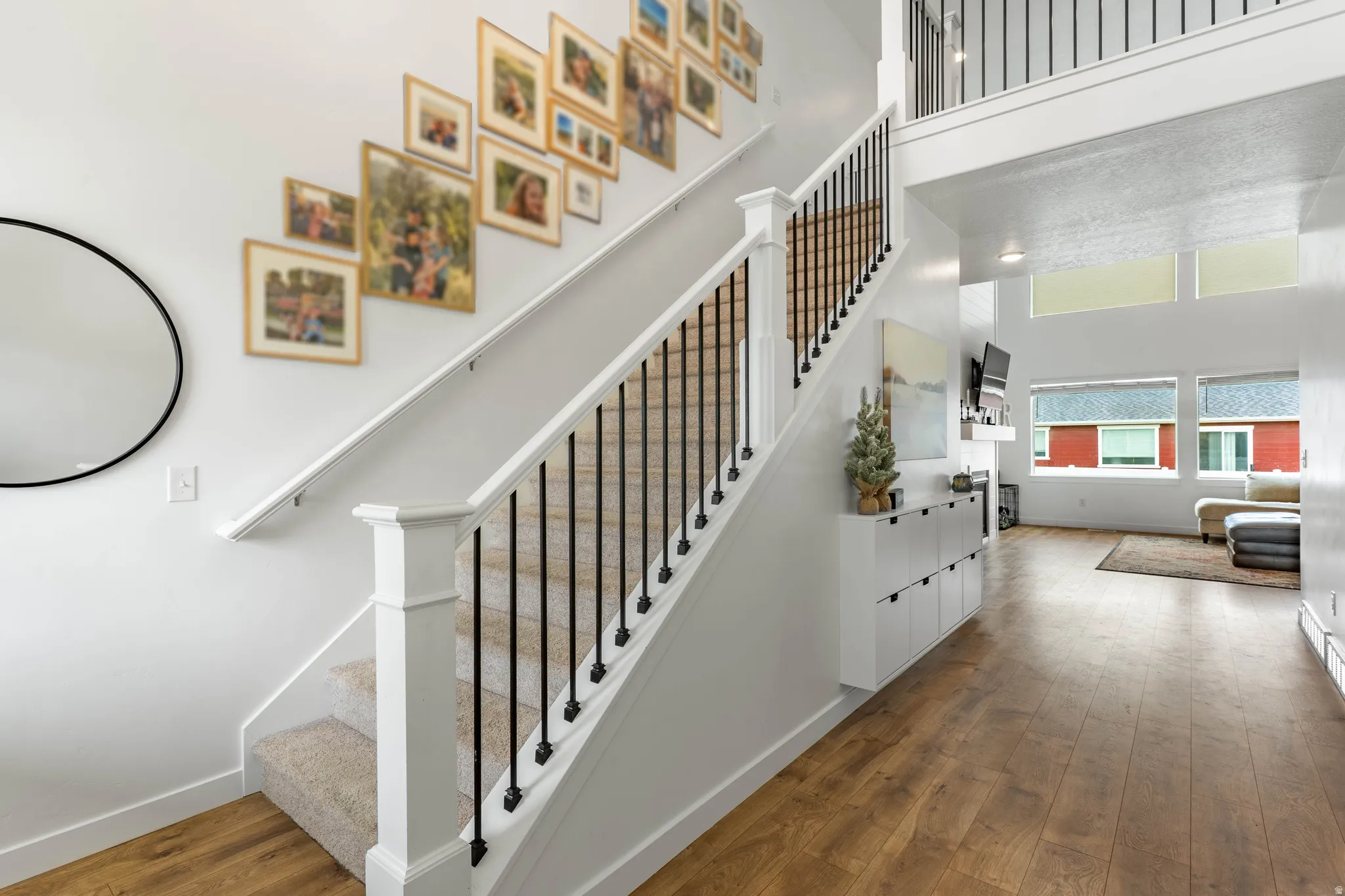 Staircase with wood-type flooring and a high ceiling