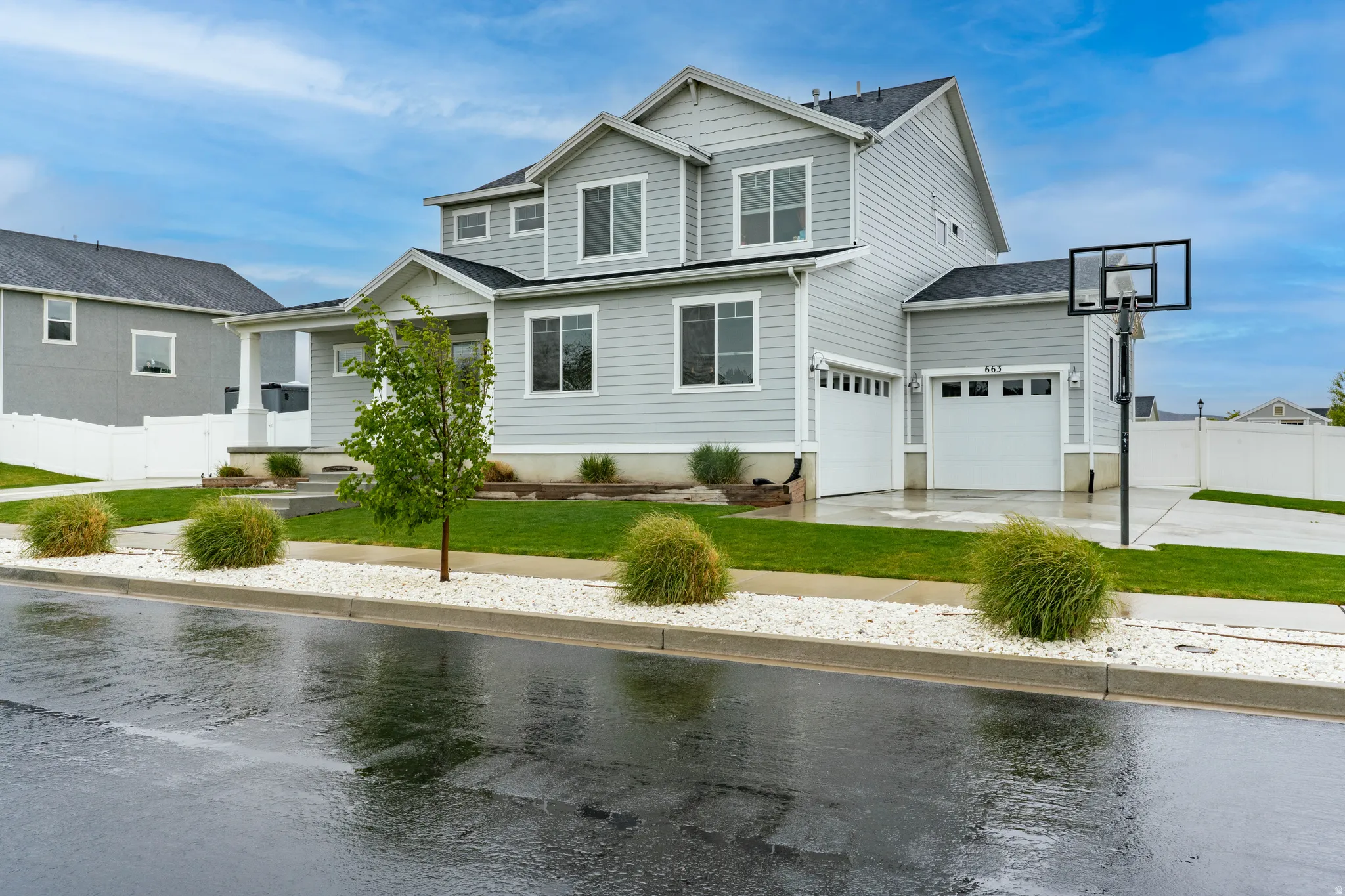 View of front of house with concrete driveway, a shingled roof, and a garage