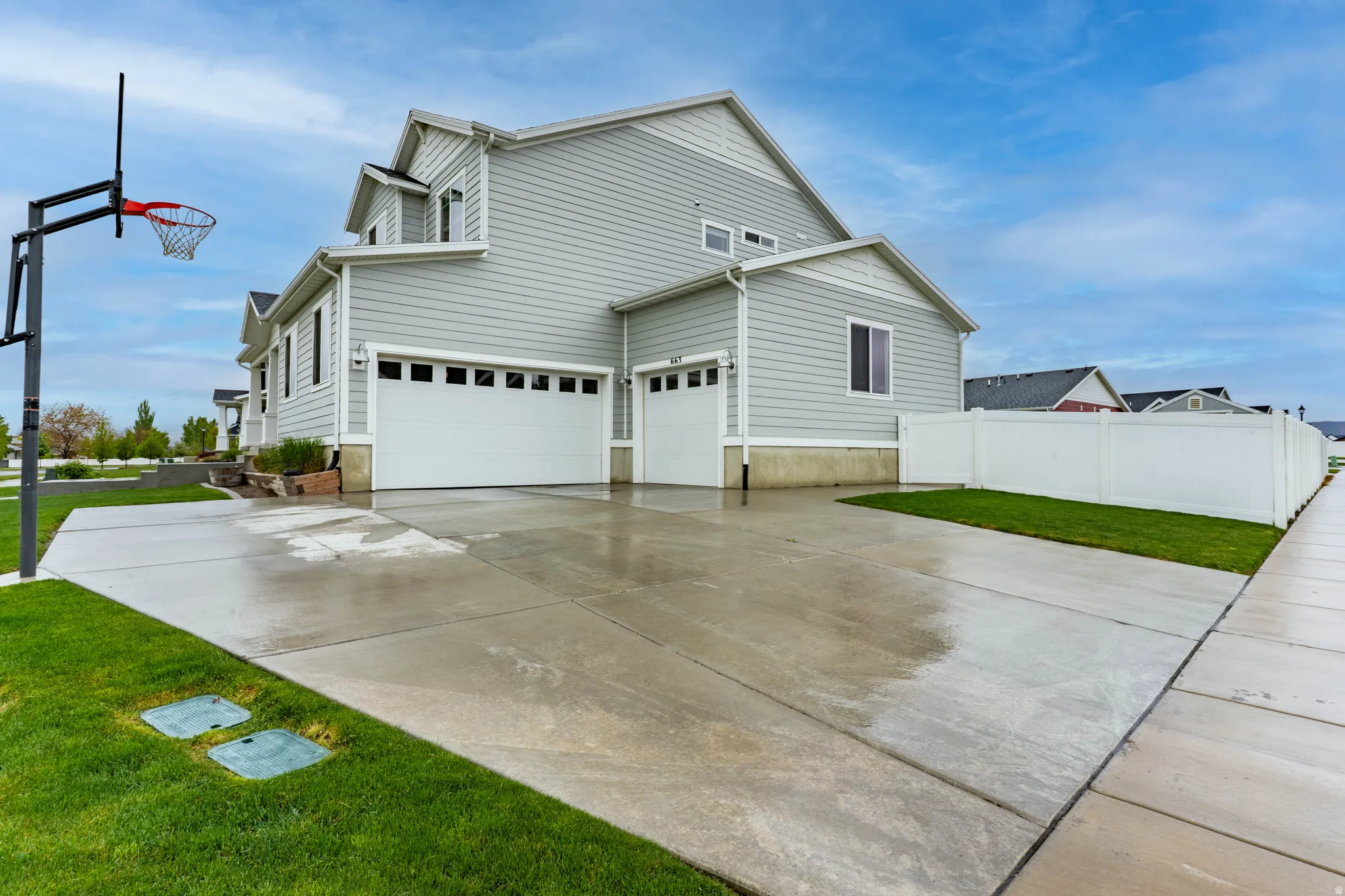 View of side of property with concrete driveway and an attached garage
