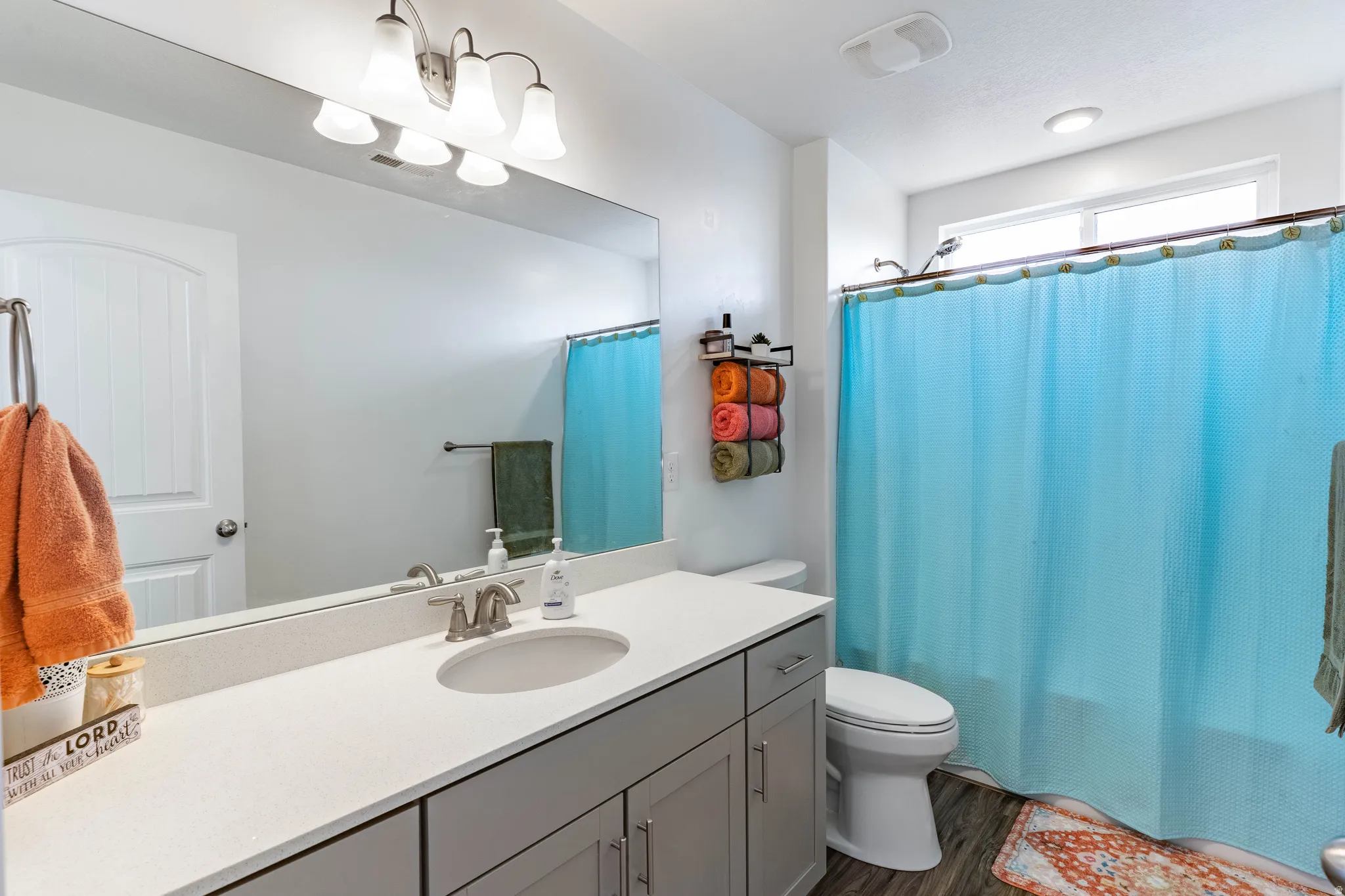 Full bath featuring vanity, dark wood-style flooring, and shower / tub combo with curtain