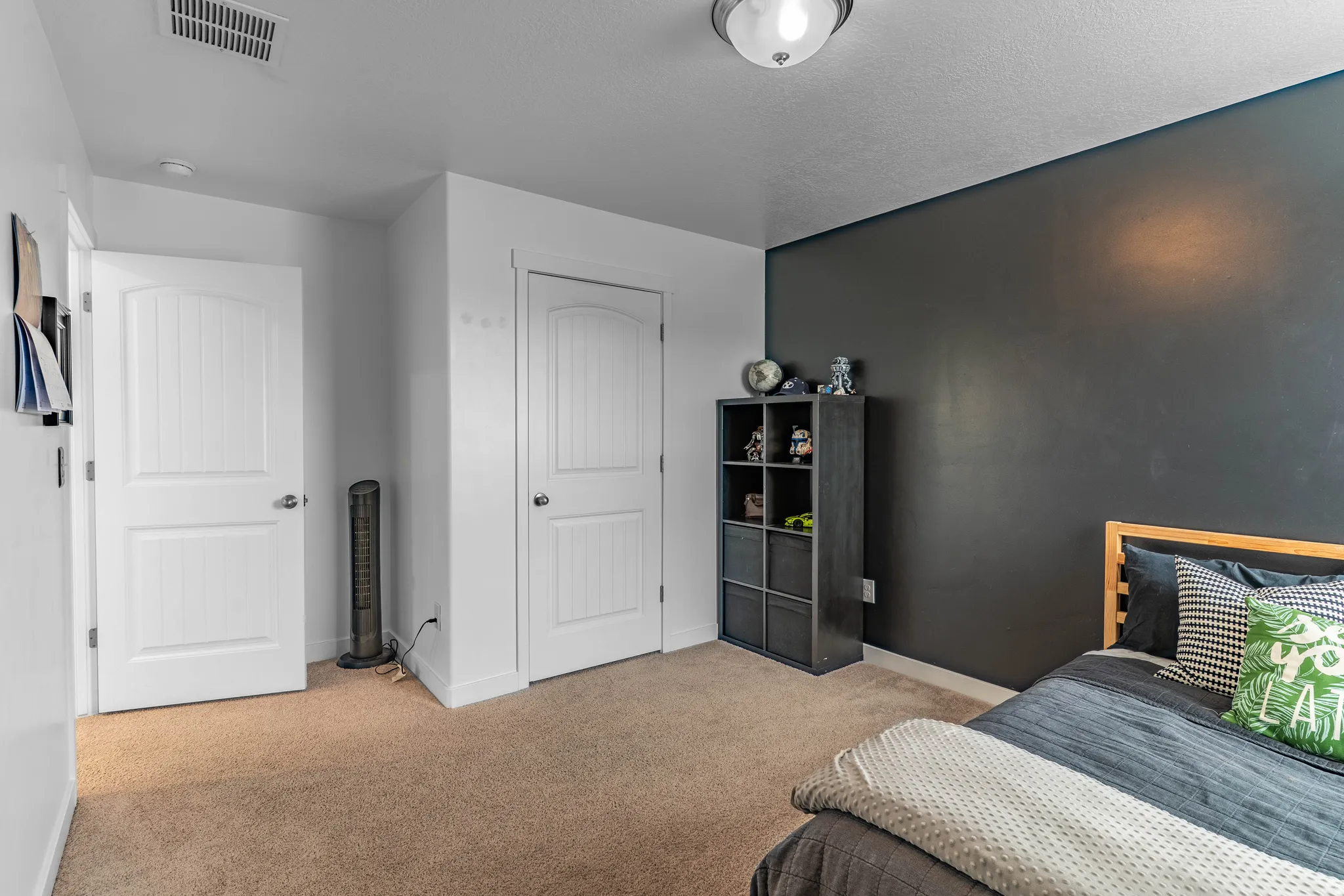 Bedroom featuring light colored carpet and baseboards