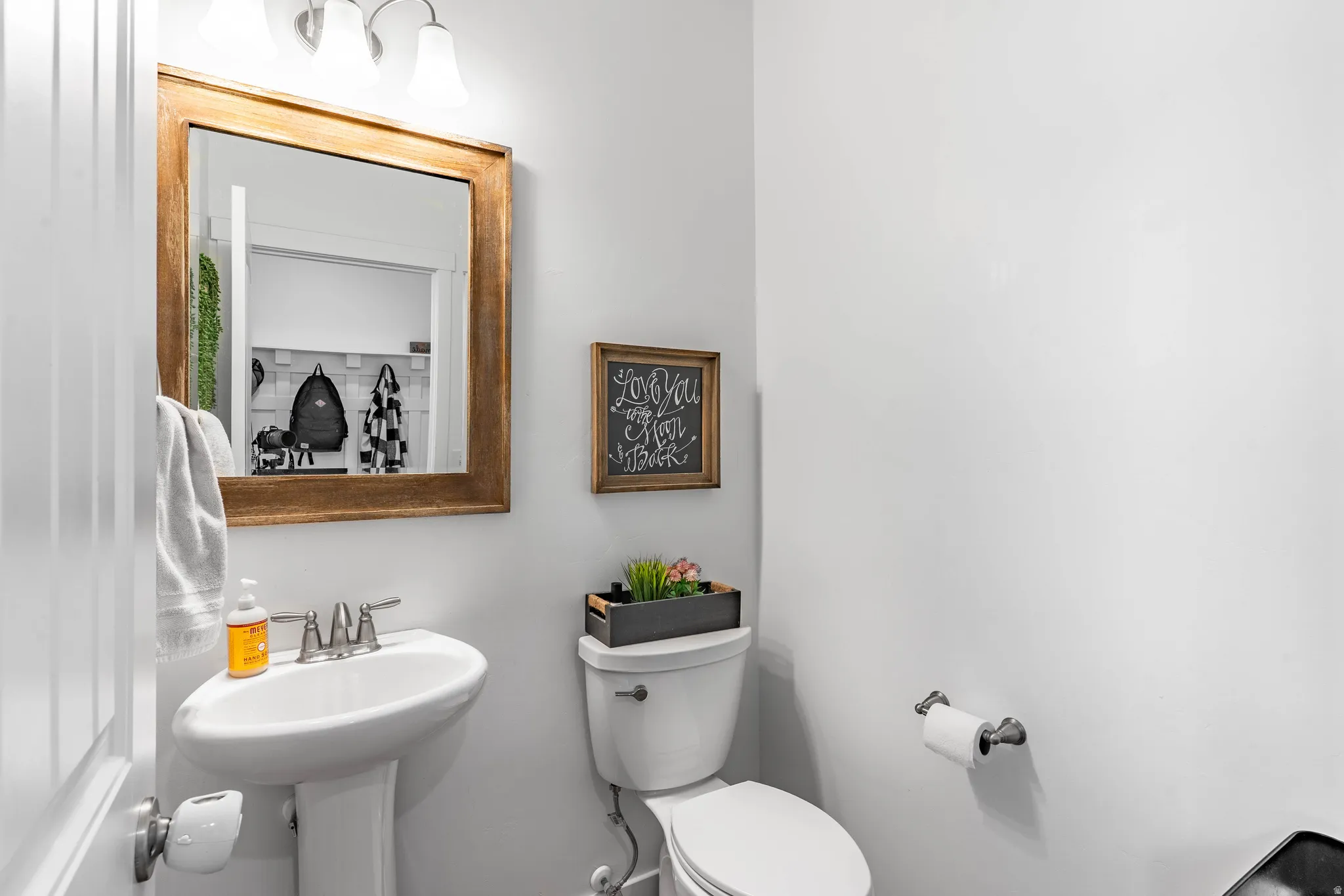 Half bath featuring toilet and a sink