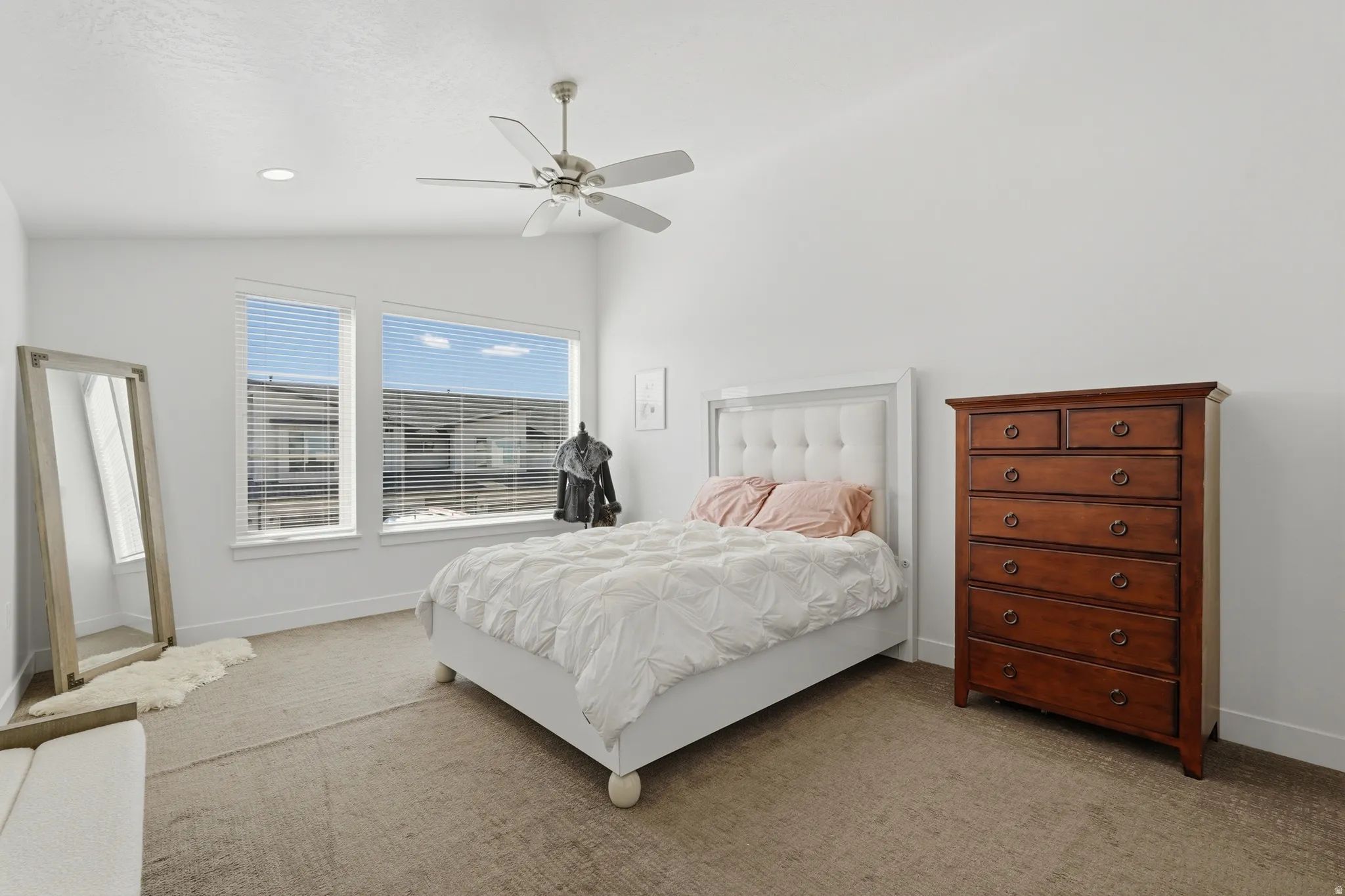 Primary Bedroom featuring vaulted ceiling, big windows, and a lot of space to spare
