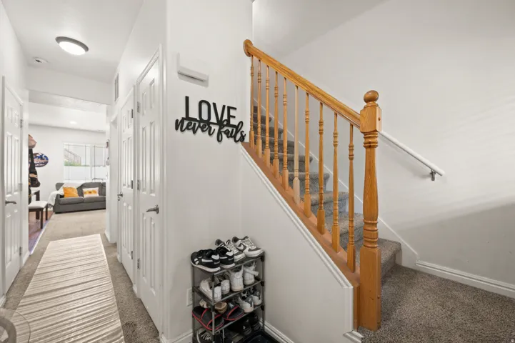 Staircase with carpet flooring and baseboards