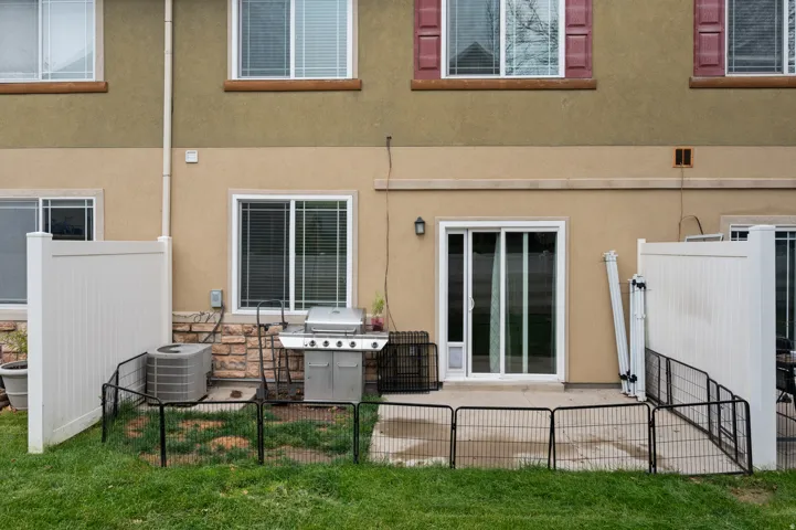 Back of property with a patio and stucco siding