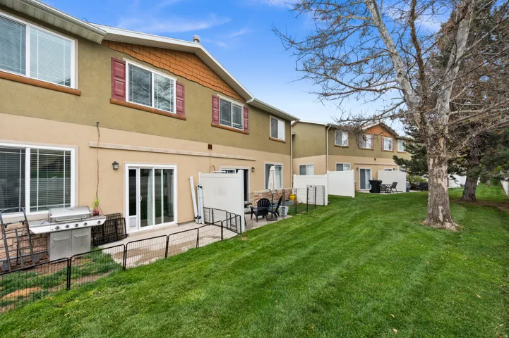 Rear view of house featuring stucco siding and a patio