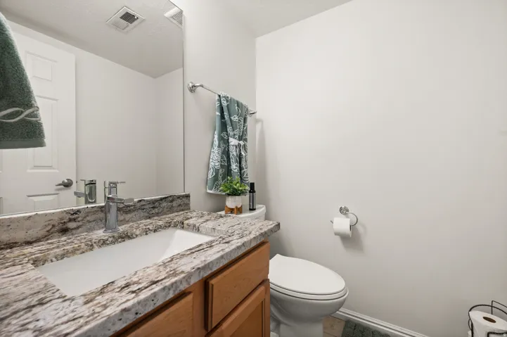 Half bathroom featuring vanity and toilet