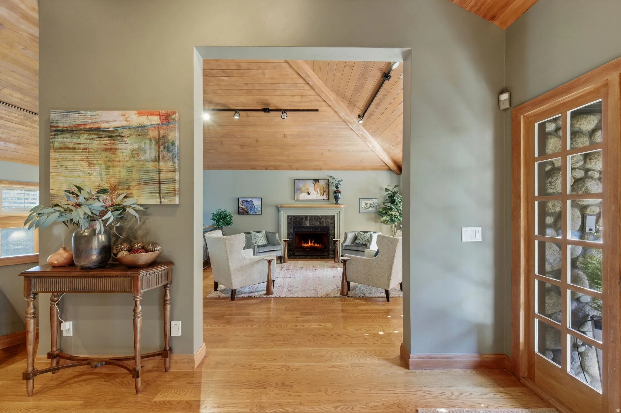 Hallway featuring a vaulted wooden ceiling and light wood-style flooring