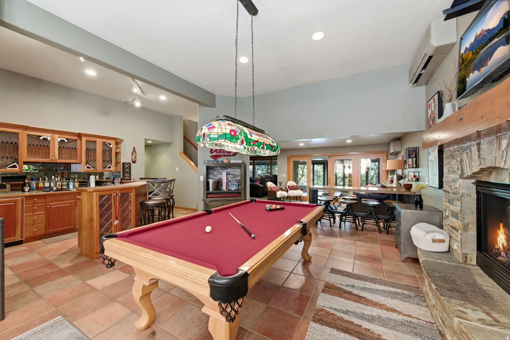 Game room with a fireplace, bar area, recessed lighting, billiards, and a high ceiling