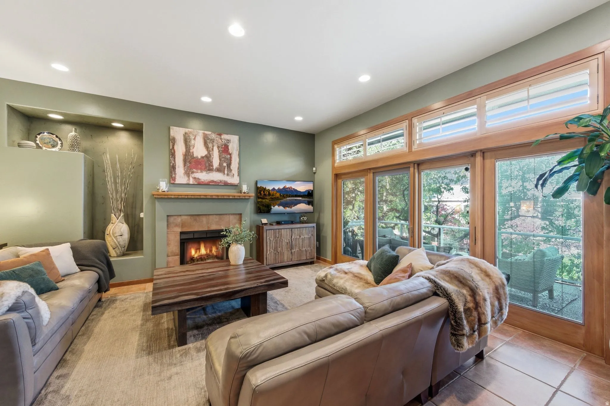 Tiled living area featuring a tile fireplace and recessed lighting