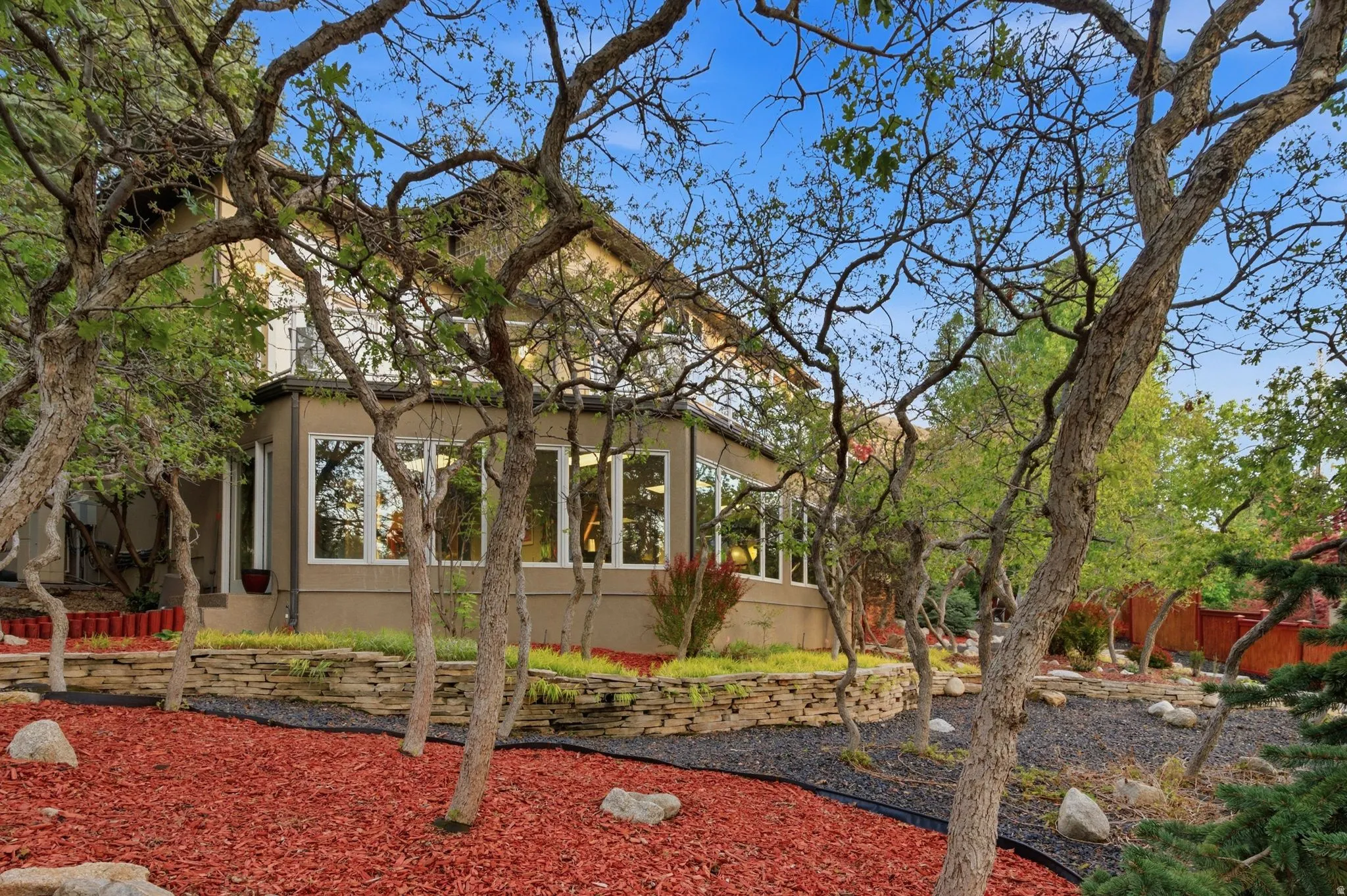 View of front of property with a sunroom and stucco siding