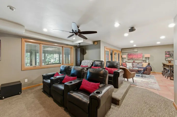 Cinema room featuring ceiling fan and recessed lighting