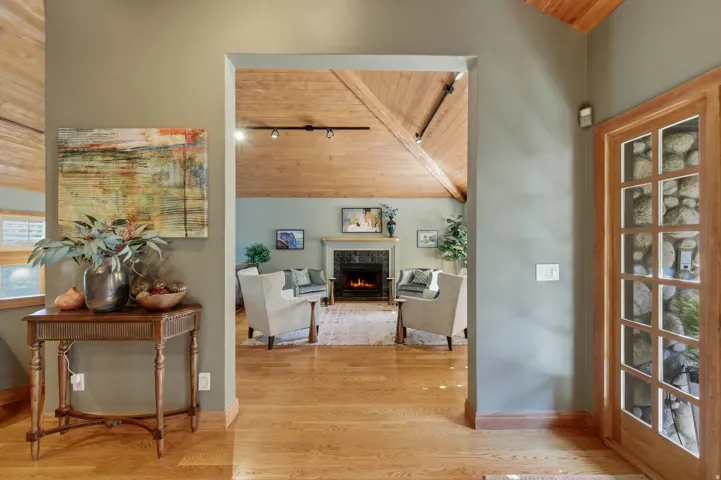 Hallway featuring a vaulted wooden ceiling and light wood-style flooring