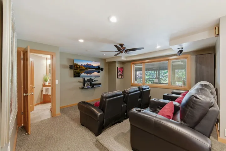 Cinema with light carpet, recessed lighting, and ceiling fan