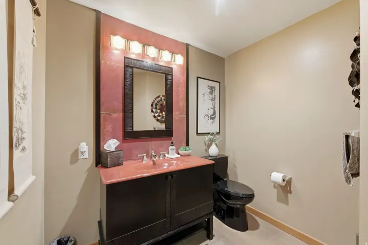 Half bathroom with vanity and light tile patterned floors