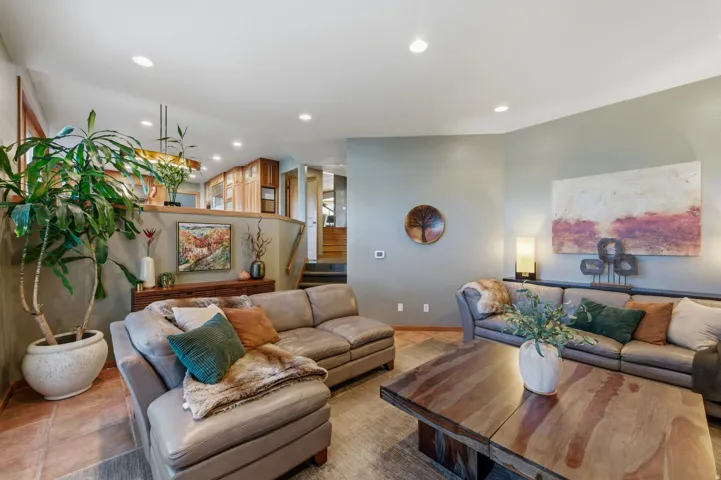Living area featuring light tile patterned floors and recessed lighting