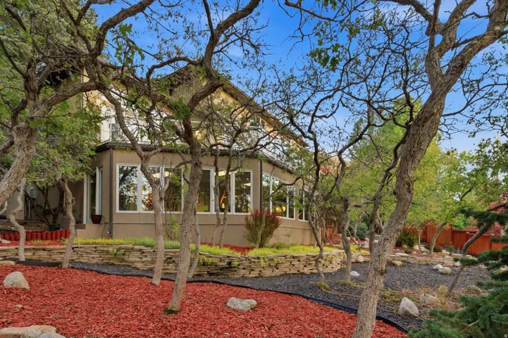 View of front of property with a sunroom and stucco siding