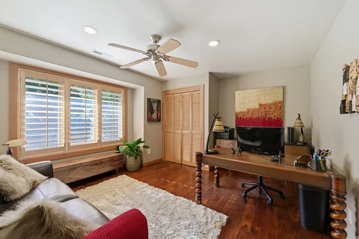 Home office with ceiling fan, dark wood-style floors, and recessed lighting