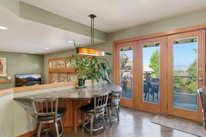 Dining space featuring recessed lighting and stone tile flooring